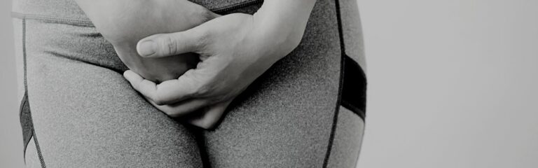 A woman using her hands to cover her croth