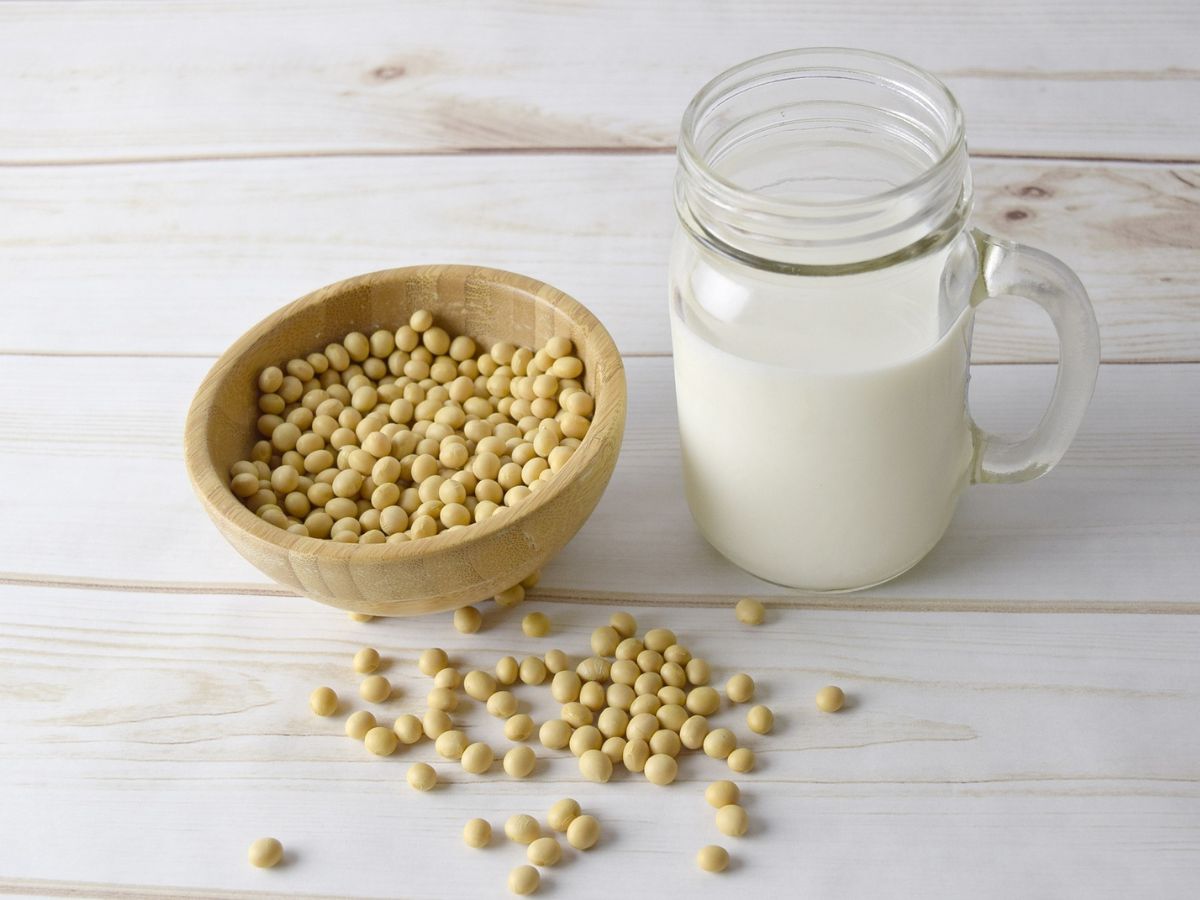 soybean in a bowl and a jar of soymilk on a white wooden table to reduce sweating