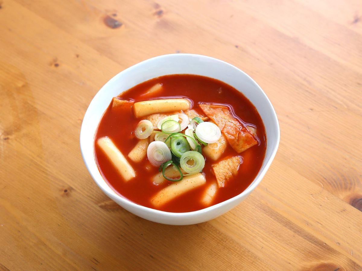 A white bowl of spicy soup on a table