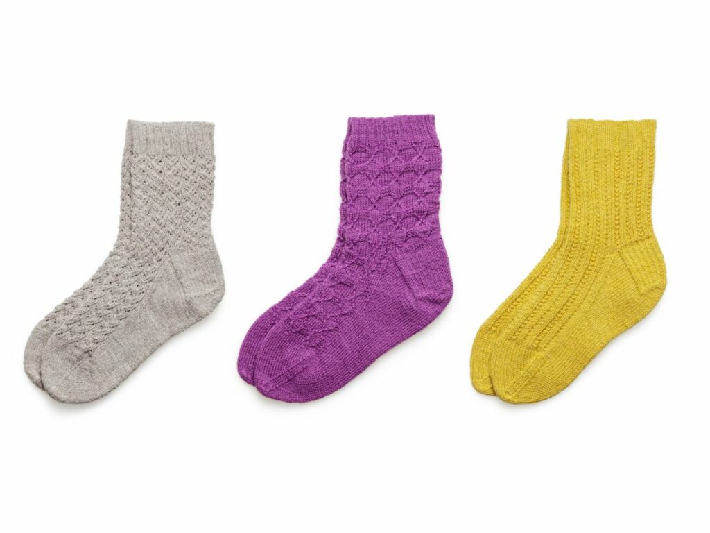 3 colours pairs of socks. A grey, purple and yellow socks